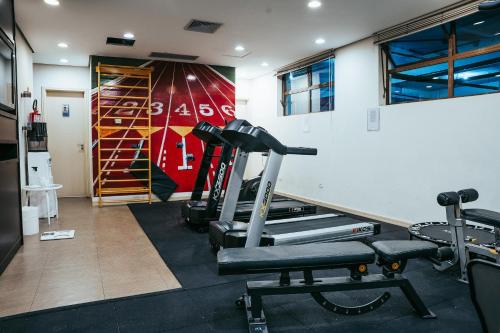 a fitness room with a gym with a treadmill at Batel Luxury - Próx Pátio Batel in Curitiba