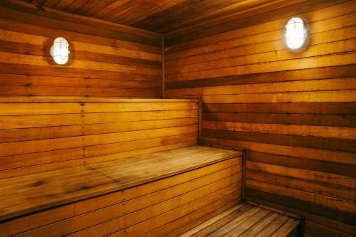 a wooden sauna with two lights on top of it at Batel Luxury - Próx Pátio Batel in Curitiba