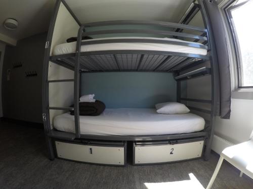 a bedroom with two bunk beds in a room at HI Lake Louise Alpine Centre - Hostel in Lake Louise