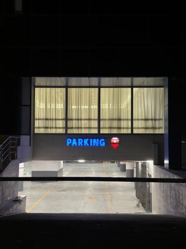 a parking lot with a parking sign in a building at Mora Hotel in Al Khobar