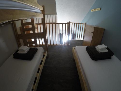 two bunk beds in a room with a hallway at HI Lake Louise Alpine Centre - Hostel in Lake Louise