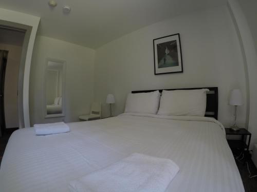 a bedroom with a large white bed with white pillows at HI Lake Louise Alpine Centre - Hostel in Lake Louise