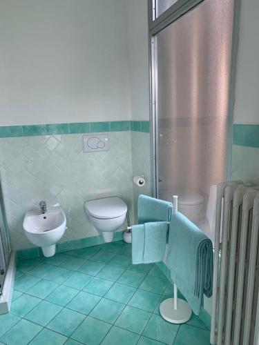 a bathroom with a sink and a toilet and a shower at Son Sogni Holiday House in Leggiuno