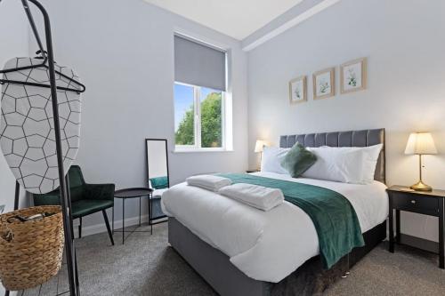 a bedroom with a large bed and a chair at Modern Apartment Free Parking Double Bed Suite 5 in Nottingham