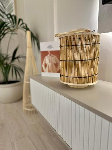 a basket sitting on top of a shelf with a plant at Lungomare Luxury Sea View Apartaments in Vlorë