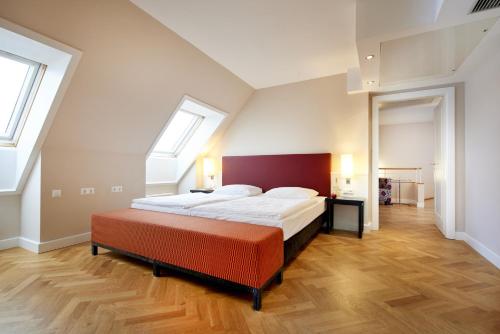 a large bedroom with a large bed and two windows at Singerstrasse 21-25 Aparthotel 350m next to St Stephen's Square in Vienna