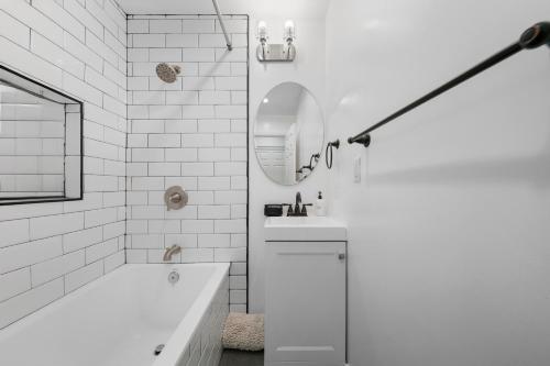 a white bathroom with a tub and a sink at # Marbella Lane - Serene & Spacious 3BR Haven in West Covina