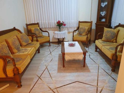 a living room with three couches and a coffee table at Atlas61 in Trabzon
