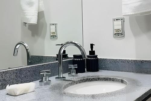 a bathroom counter with a sink and a sink at Zyz Centro in Sao Paulo