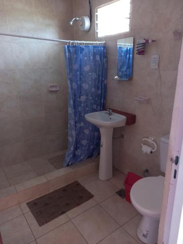 a bathroom with a shower and a sink and a toilet at Bungalows "El Poli 2" in San José