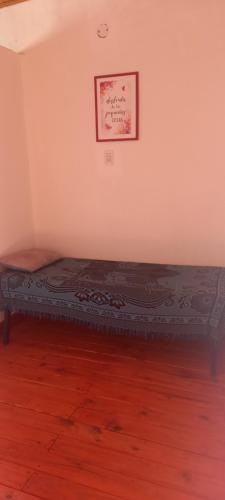 a bed in a room with a picture on the wall at Bungalows "El Poli 2" in San José