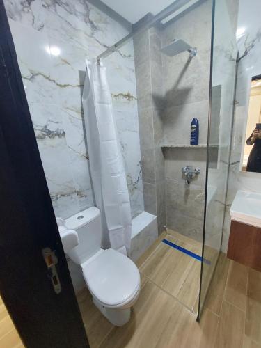 a bathroom with a toilet and a shower and a sink at Fenêtre sur le paradis in Saidia 