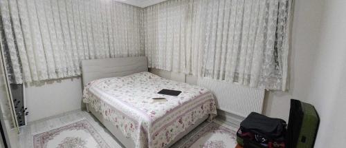 a small bedroom with a bed with a book on it at Atlas6161 in Trabzon