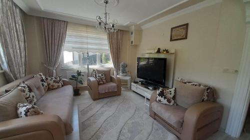 a living room with couches and a flat screen tv at Atlas6161 in Trabzon