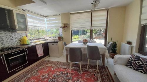 a kitchen with a table and chairs in a room at Atlas6161 in Trabzon