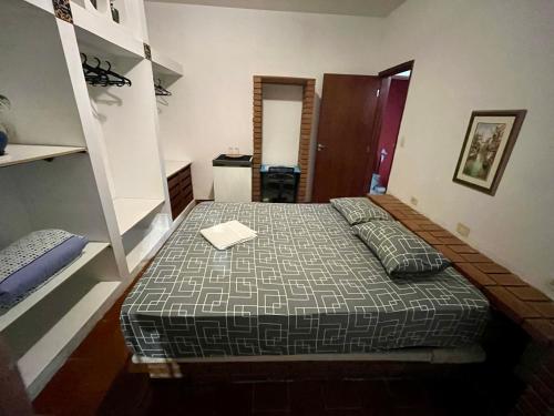 a bedroom with a bed with a book on it at Suíte independente na Vila Sônia in Sao Paulo