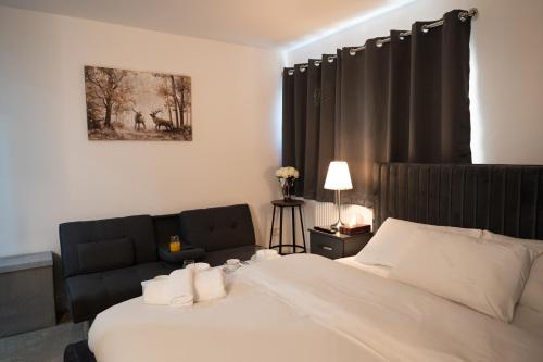 a hotel room with a bed and a couch at Digbeth Aparthotel in Birmingham
