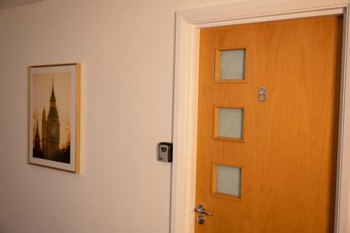 a door to a room with a picture of a building at Digbeth Aparthotel in Birmingham