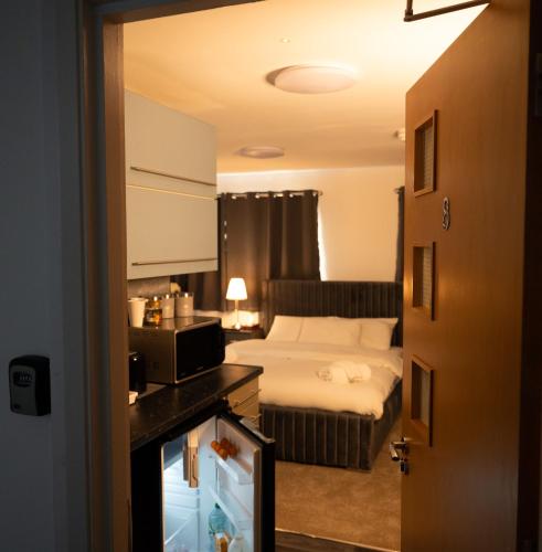 a hotel room with a bed and a television at Digbeth Aparthotel in Birmingham