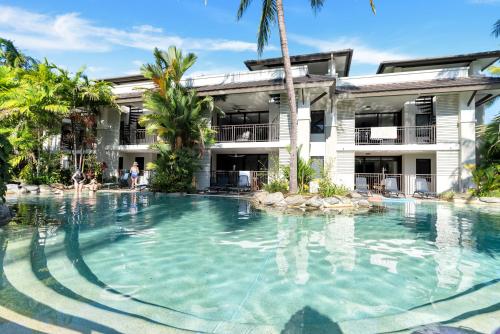 a swimming pool in front of a resort at Resort-style Swim Out - A Poolside Oasis in Port Douglas