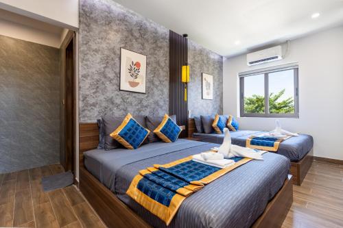 Postel nebo postele na pokoji v ubytování Hai Hội Villa Hoi An