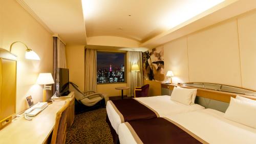 a hotel room with a large bed and a window at Ginza Creston in Tokyo