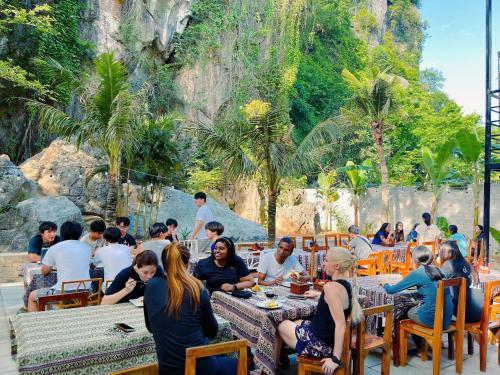 a group of people sitting at tables in a restaurant at Discovery Lodge Phong Nha in Cừ Lạc