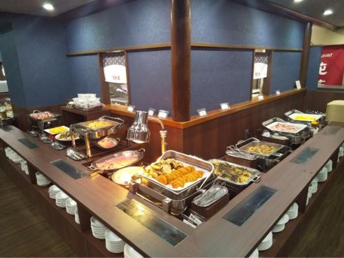 a buffet line with many different types of food at Hotel Route-Inn Minokamo in Minokamo