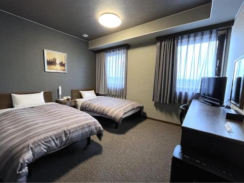 Voodi või voodid majutusasutuse Hotel Route-Inn Minokamo toas