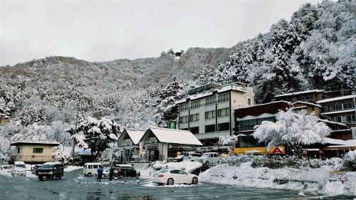 a town covered in snow with buildings and cars at Beehive Basecamp Explore Ski Play and Make Memories in Parowan