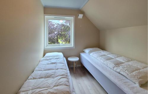 two beds in a small room with a window at Amazing Home In Vikebygd With Wifi in Vikebygd