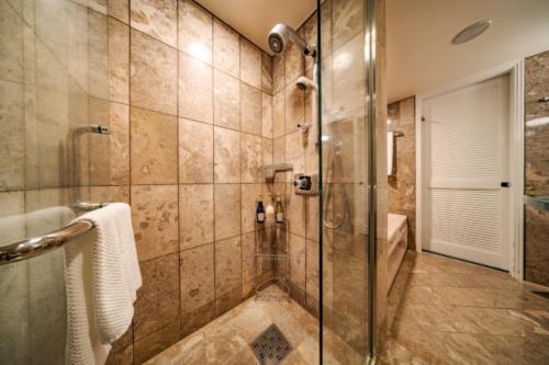 a bathroom with a shower with a glass door at Kurashiki Royal Art Hotel in Kurashiki