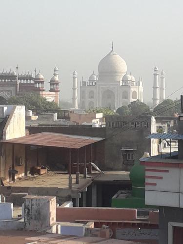 a view of the taj mahal from the roofs of buildings at Sai Palace in Agra