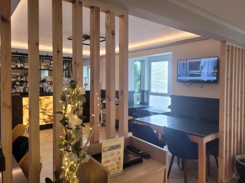 a kitchen and dining room with a table and chairs at The Gatwick White House Hotel in Horley