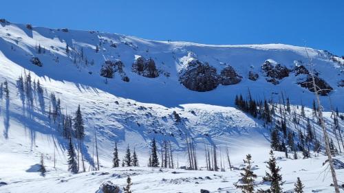 a snow covered mountain with trees in the foreground at Beehive Basecamp Explore Ski Play and Make Memories in Parowan
