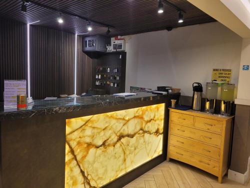 a kitchen with a counter with a marble counter top at The Gatwick White House Hotel in Horley