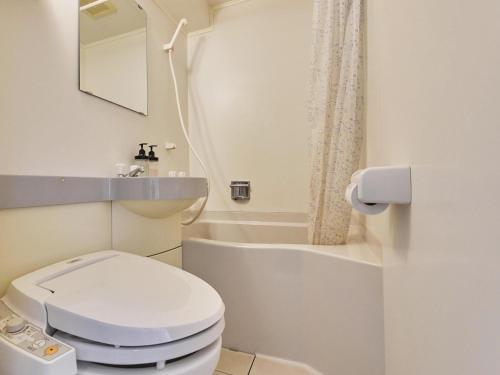 a bathroom with a toilet and a sink and a mirror at 2-51 Miyamaecho - Hotel / Vacation STAY 8659 in Kumagaya