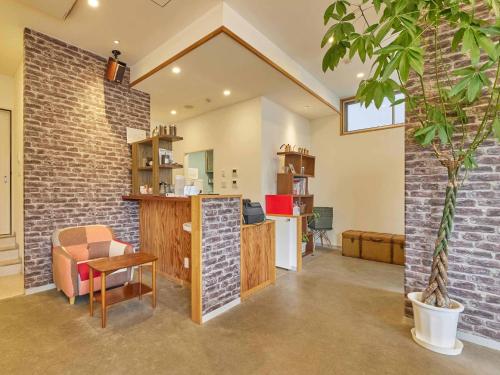 an office with a brick wall and a table and a chair at Kumagaya - Hotel - Vacation STAY 88851 in Kumagaya