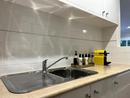 a kitchen with a sink and a counter top at Unicorn Farm-Tranquil Sauna Farmstay Escape in Magpie