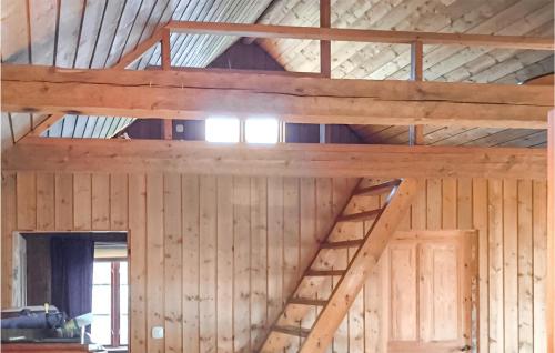 a wooden attic with a staircase in a room at Cozy Home In Växjö With Sauna in Hällevik