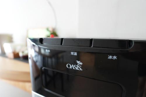 a black microwave sitting on top of a table at Zhaohong homestay in Yuchi