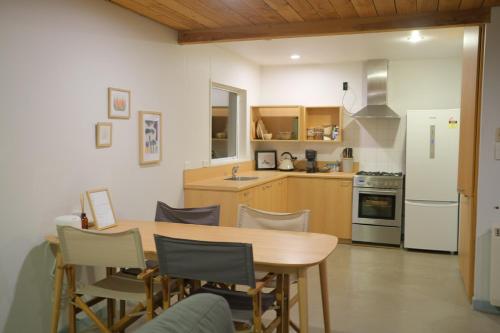 a kitchen with a wooden table and chairs at Sunrise Mountain View Cabin Retreat in Springfield