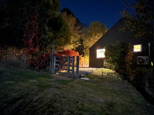 a barn lit up at night with a gate at Sunrise Mountain View Cabin Retreat in Springfield
