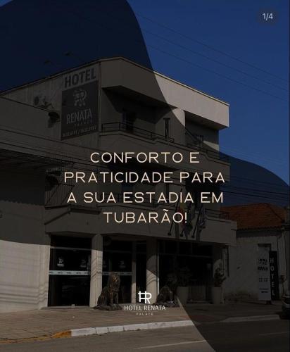 a hotel with a sign on the front of it at Hotel Renata Tubarão in Tubarão