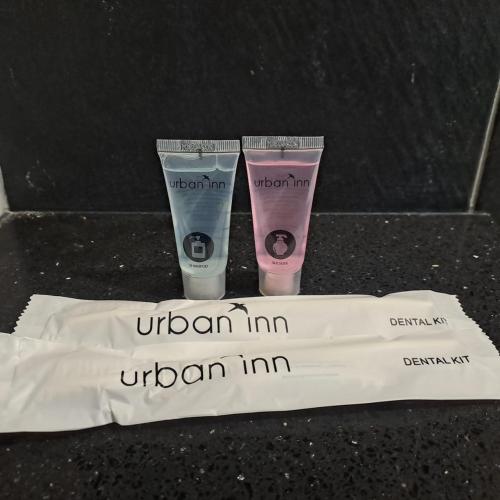 two tubes ofodorizers sitting on top of a towel at Urban Inn, Myra Meranti in Cyberjaya