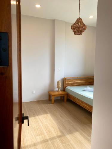 a bedroom with a bed and a table in it at Cozy, Comfy and Spacious Apartment in Olón