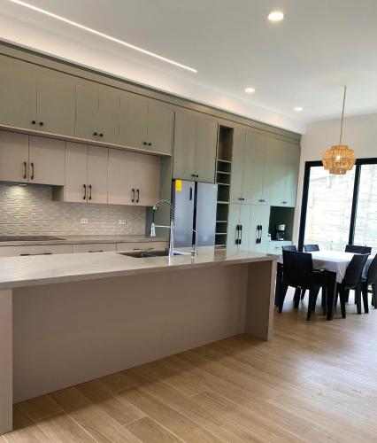 a kitchen with a table and chairs and a dining room at Cozy, Comfy and Spacious Apartment in Olón