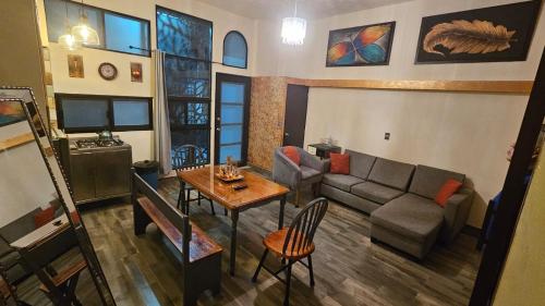 a living room with a couch and a table at Departamento Árbol in Atlixco