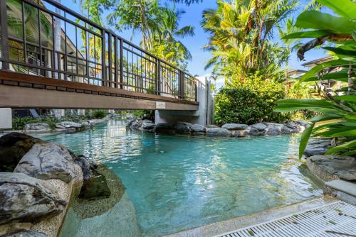 a bridge over a river with a walkway at Resort-style Swim Out - A Poolside Oasis in Port Douglas