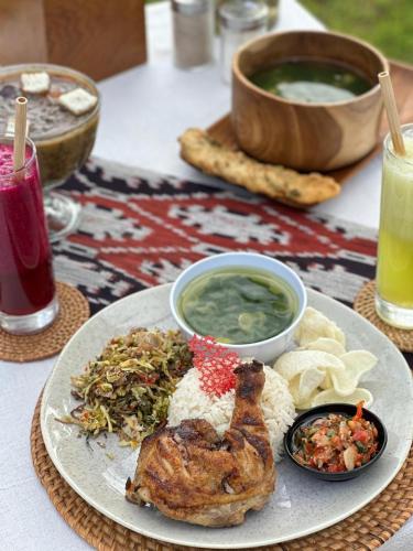 a plate of food with a chicken on a table at Morika Villa in Rua